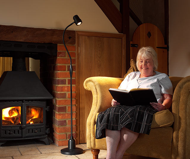 Woman reading with HD Essential floor light