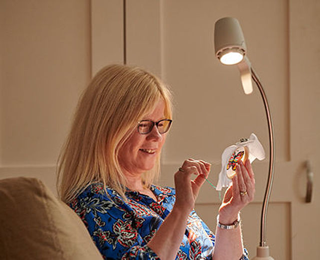 Woman sewing under HD Light