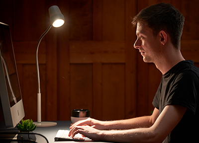 Man reading with a HD Essential Table Light