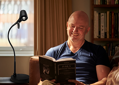Man reading with a HD Pro Table Light