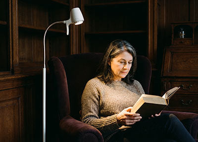 Woman reading with a HD Floor Light