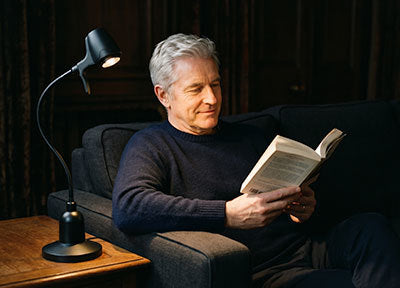 Man reading with a HD Original Floor Light