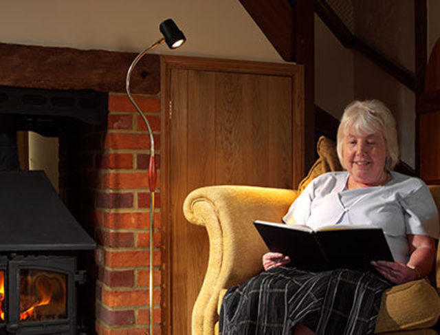 Woman reading with HD Essential Floor Light