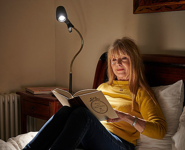 Woman reading with HD table light