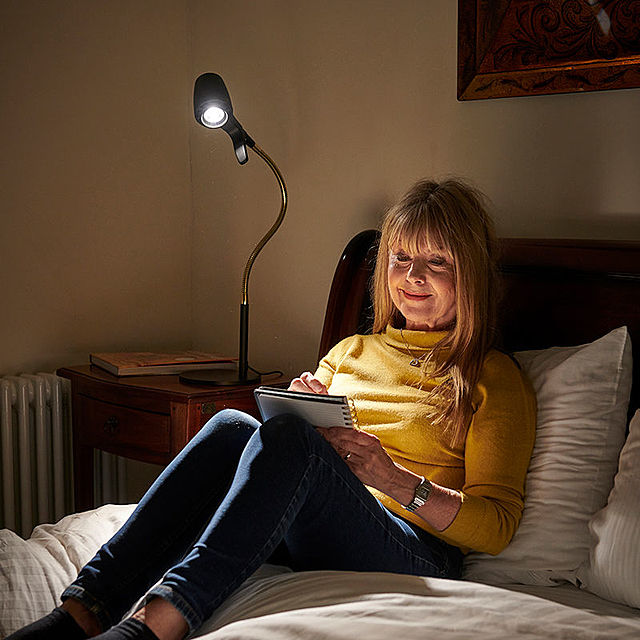 Woman reading with HD table light