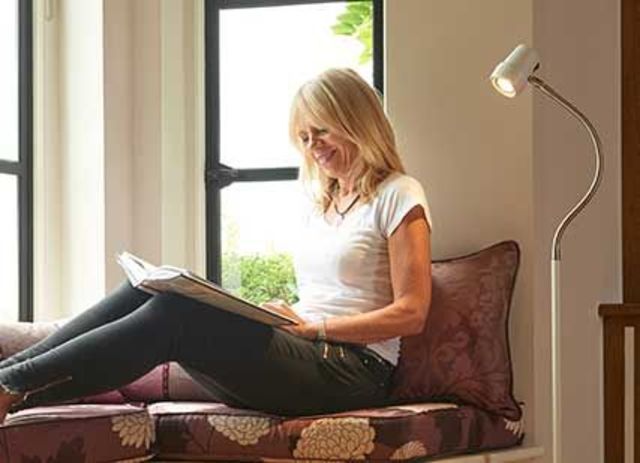 Woman reading with HD Essential floor light