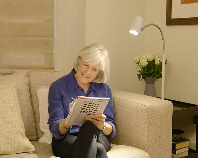 Woman doing a crossword - HD Essential floor light