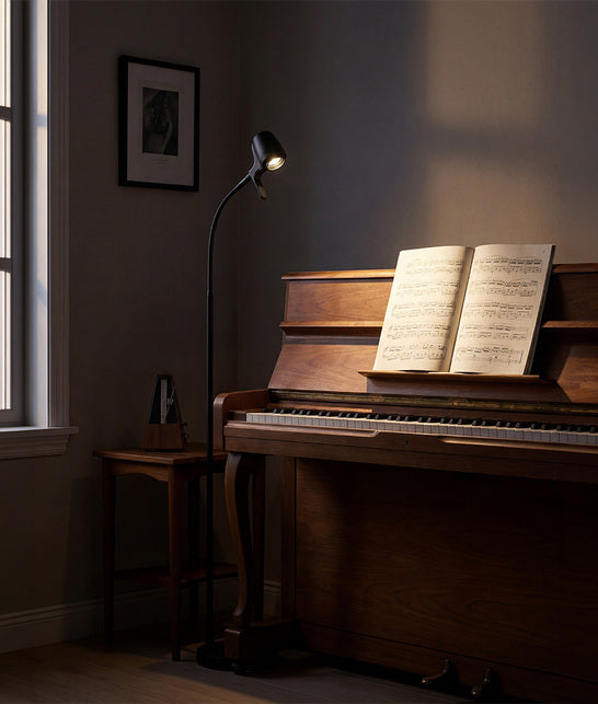 HD floor light next to piano